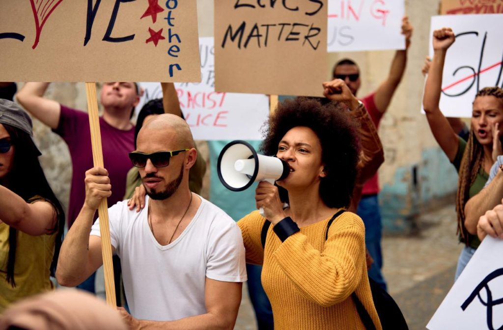 A protest with one of its members holding a megaphone.