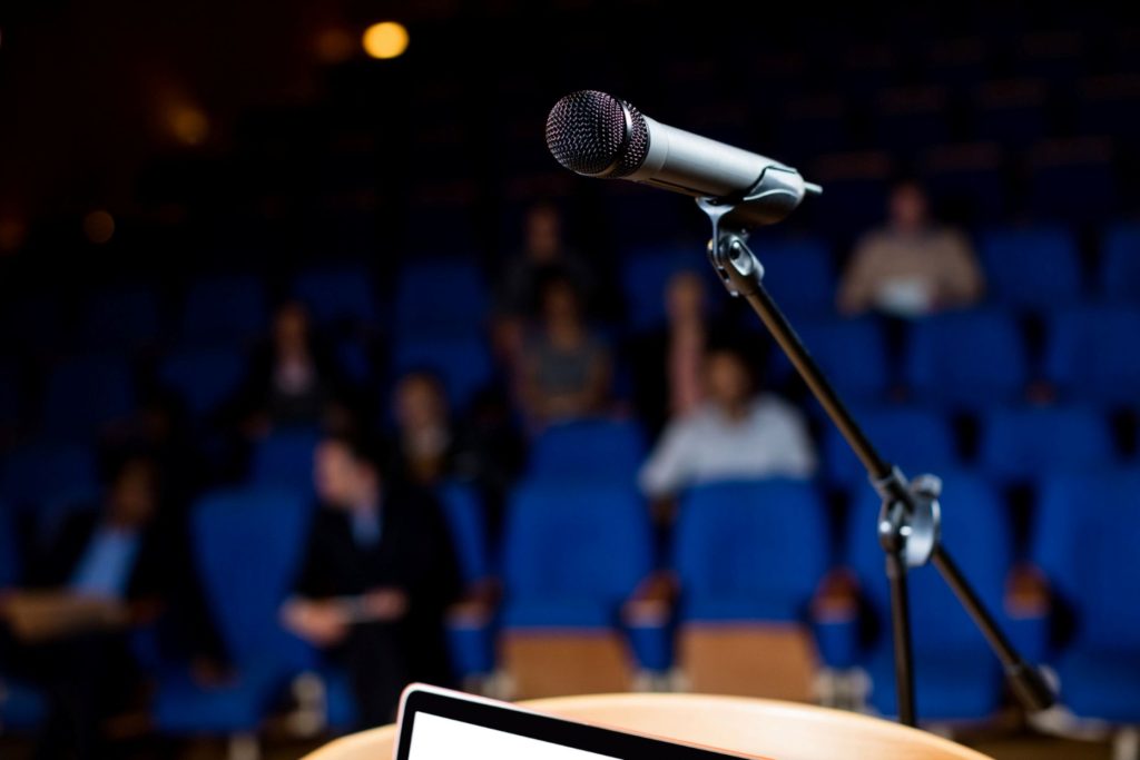 A microphone standing beside a podium.